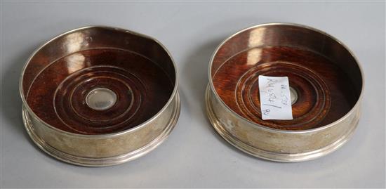 A pair of modern silver wine coasters, 12.9cm.